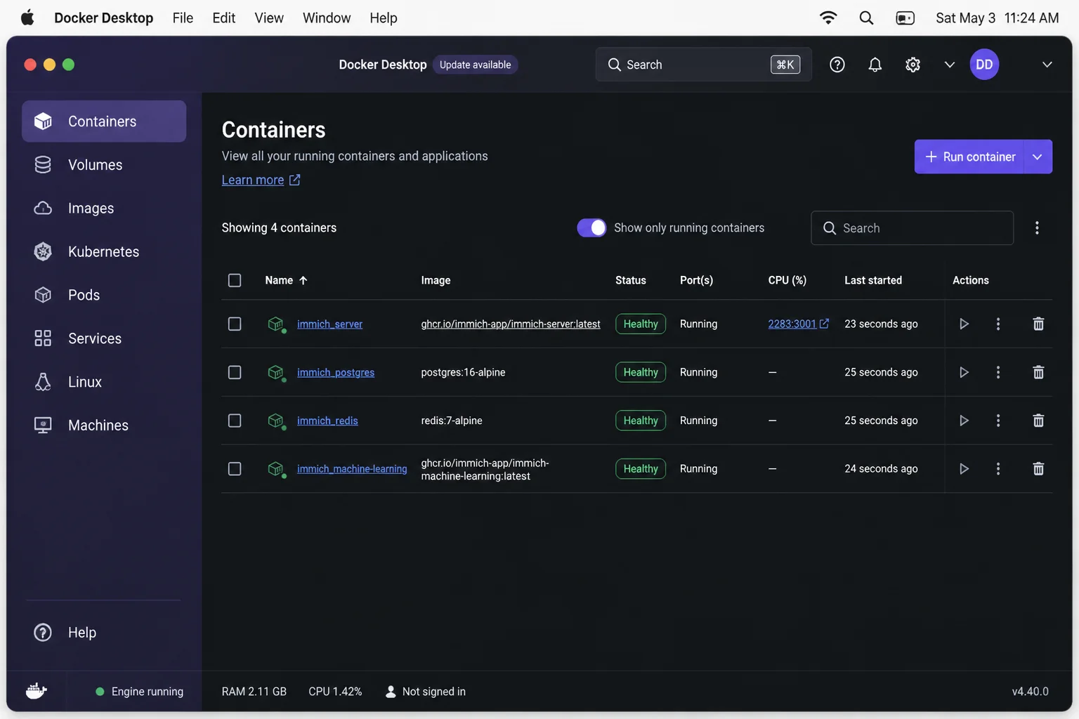 Docker Desktop Containers view on macOS showing the application stack, running services, health state, and published web port